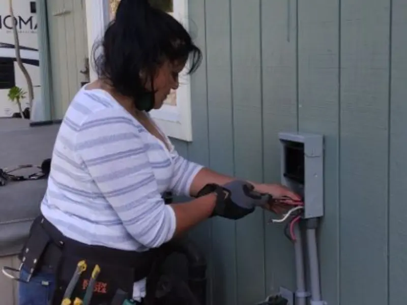 Licensed electrician wiring an exterior subpanel in Tillamook